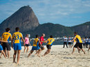 Former England Sevens player Ollie Phillips plays with locals at Flamengo beach
