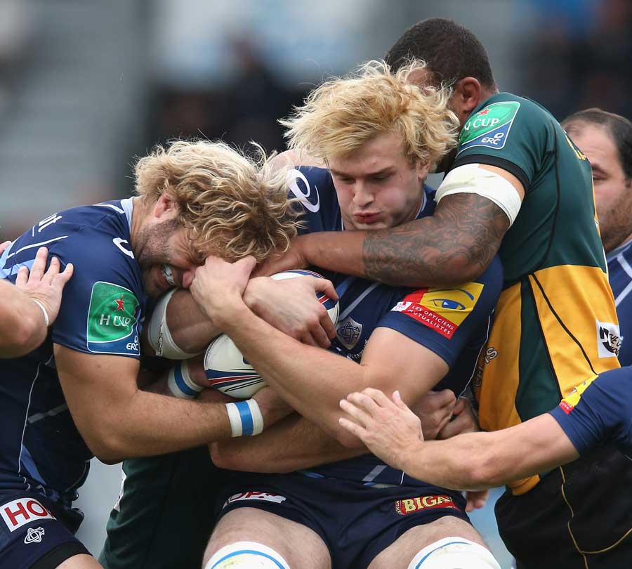 Castres' Richie Gray is tackled by Courtney Lawes