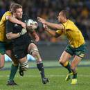Australia's Stephen Moore and Quade Cooper tackle New Zealand's Richie McCaw