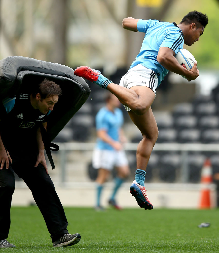 Julian Savea  leaps over a tackle bag during a training session