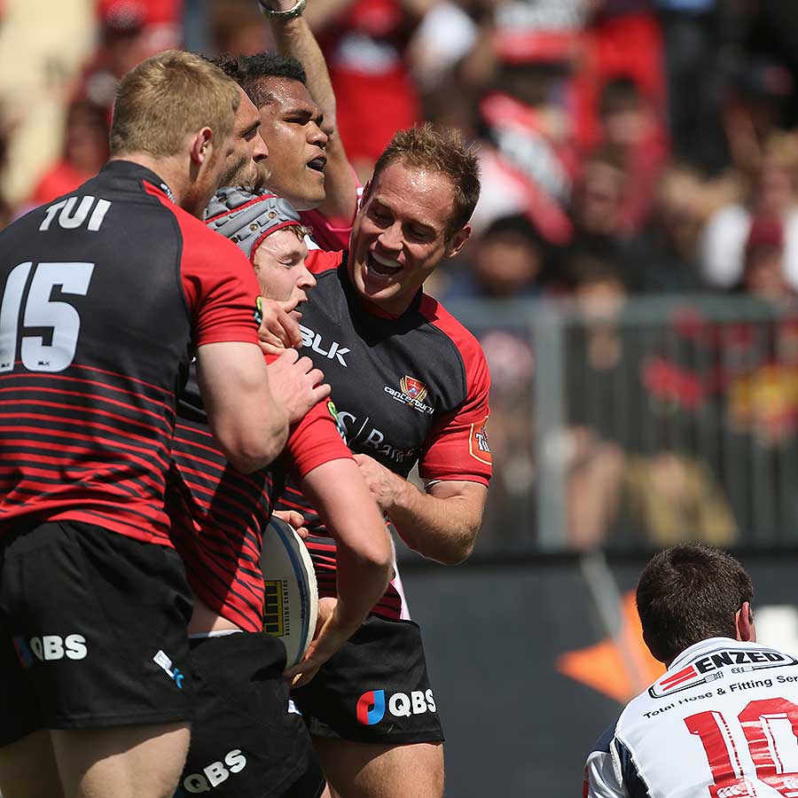 Canterbury's Johnny McNicholl and Andy Ellis congratulate Tyler Bleyendaal for his try