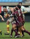 Perpignan's lock Olivier Olibeau (L) looks to break the tackle of Bourgoin lock Camille Levast