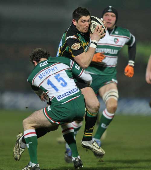 Northampton's James Downey is tackled by Leicester's Geordan Murphy 