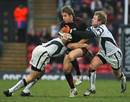 Saracens' Chris Wyles is tackled by Bristol's Ed Barnes (R) and Robert Sidoli