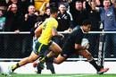 New Zealand's Julian Savea beats Israel Folau to score a try