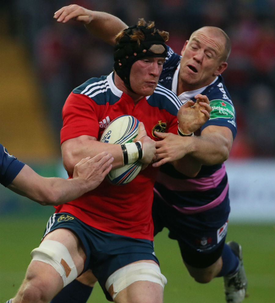 Mike Tindall tries to bring down Munster's Niall Ronan 