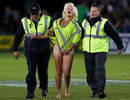 A female streaker is removed