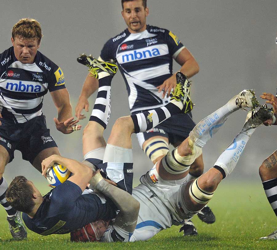 Sale Sharks' Dwayne Peel is hauled to the ground by Tom Johnson
