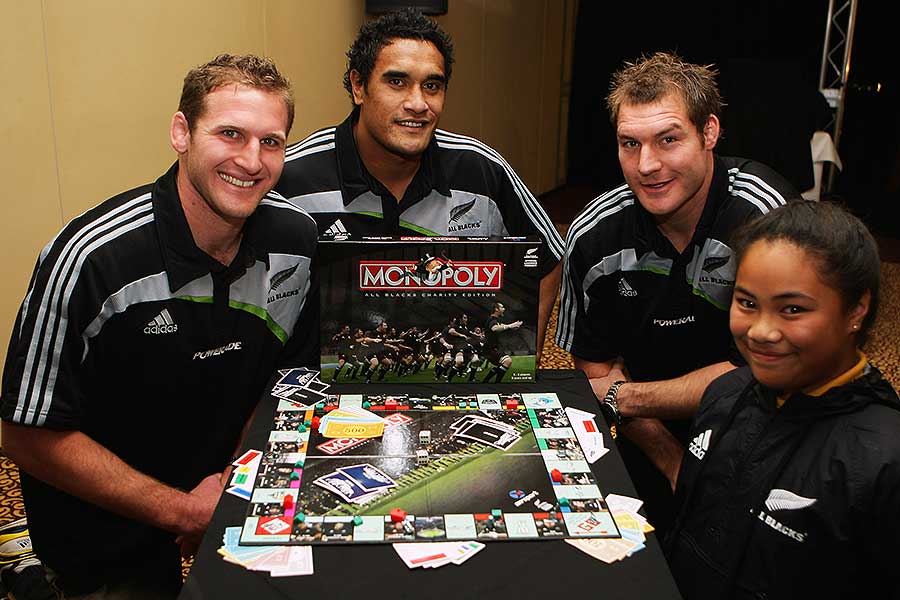 New Zealand's Kieran Read, Jerome Kaino and Ali Williams pose with Samantha Leupolo to launch the New Zealand All Blacks Monopoly game to raise funds for of Kids Can