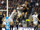 New Zealand's Israel Dagg contests a high ball with England pair Courtney Lawes and Chris Ashton