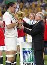 England skipper Martin Johnson receives the trophy from  Australian Prime Minister John Howard