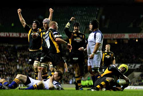 Wasps celebrate as Serge Betsen goes over to score a try