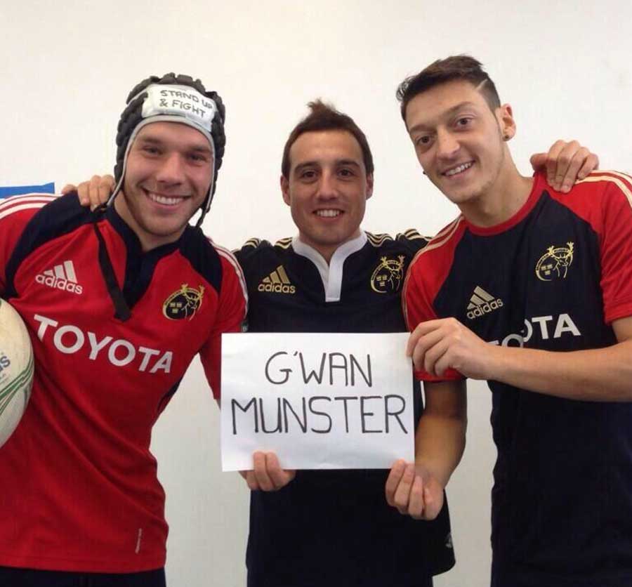 Arsenal's Lukas Podolski, Santi Cazorla and Mesut Ozil show their support for Munster