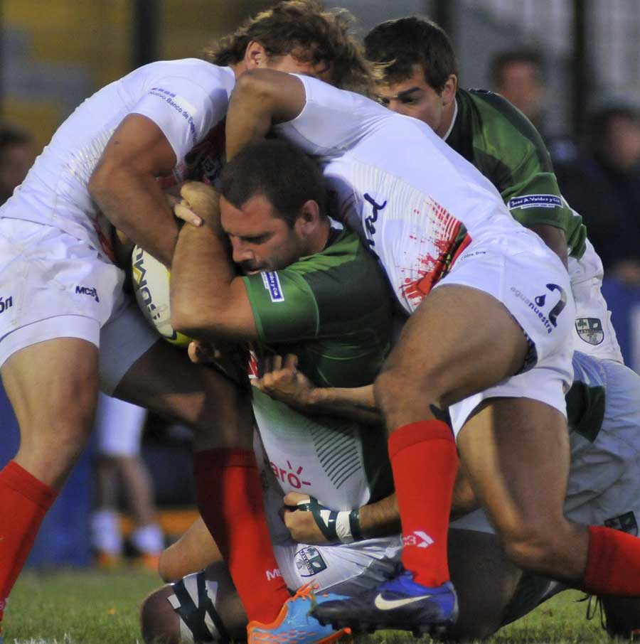 Players try to get hold of the ball during a match between Rosario and Trebol during the XXV Punta del Este Rugby Sevens