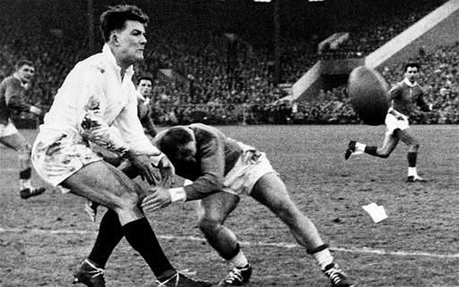 Gordon Waddell passes the ball as he is tackled by Alfred Roques