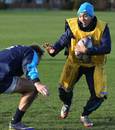 England's Marcus Watson fends off a tackler in training
