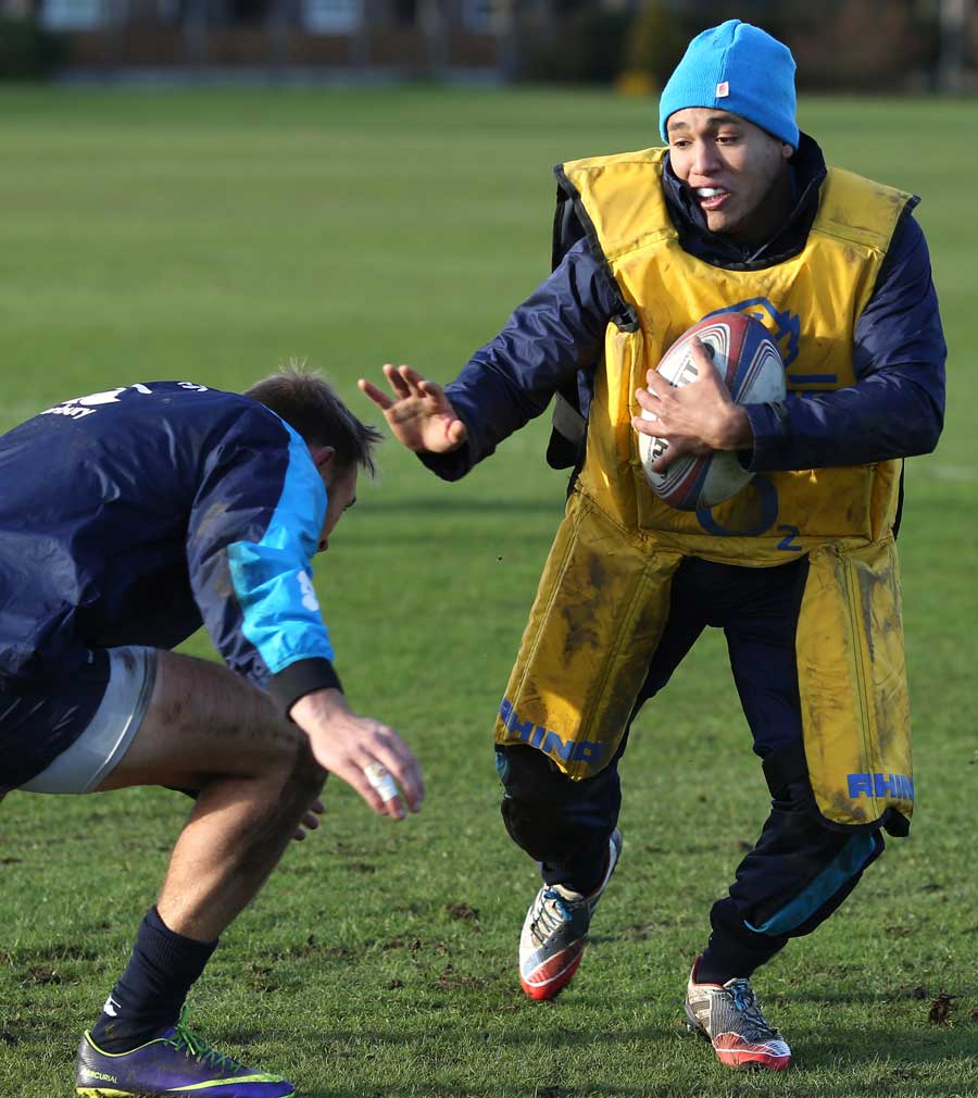 England's Marcus Watson fends off a tackler in training