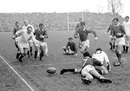 England's Philip Judd (l) chases the loose ball after teammate Bob Hearn (13) was tackled by France's Christian Carrere (7)
