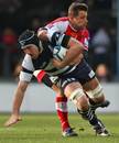 Bristol's Roy Winters is tackled by Montpellier's Frikkie Welsh