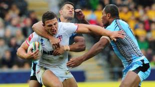England's Sam Burgess attempts to force his way through the Fiji defence, England v Fiji, Rugby League World Cup, KC Stadium, Hull, November 9, 2013