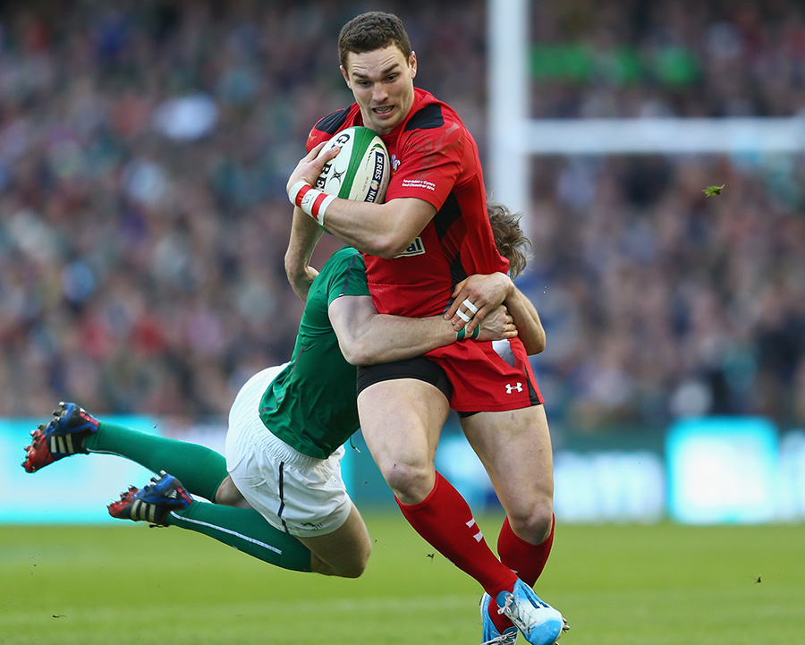 George North draws a tackle from Ireland's Andrew Trimble