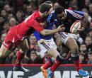 France's Mathieu Bastareaud forces his way past George North