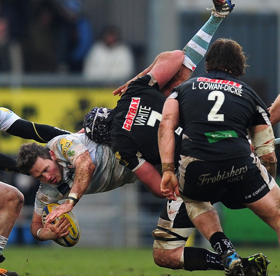 Exeter's Ben White dump tackles Darren Allinson, for which he recieves a yellow card