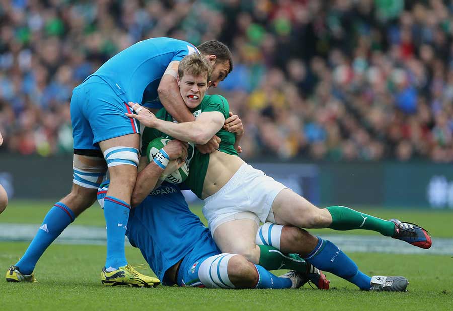 Andrew Trimble is tackled by Italy's Marco Bortolami