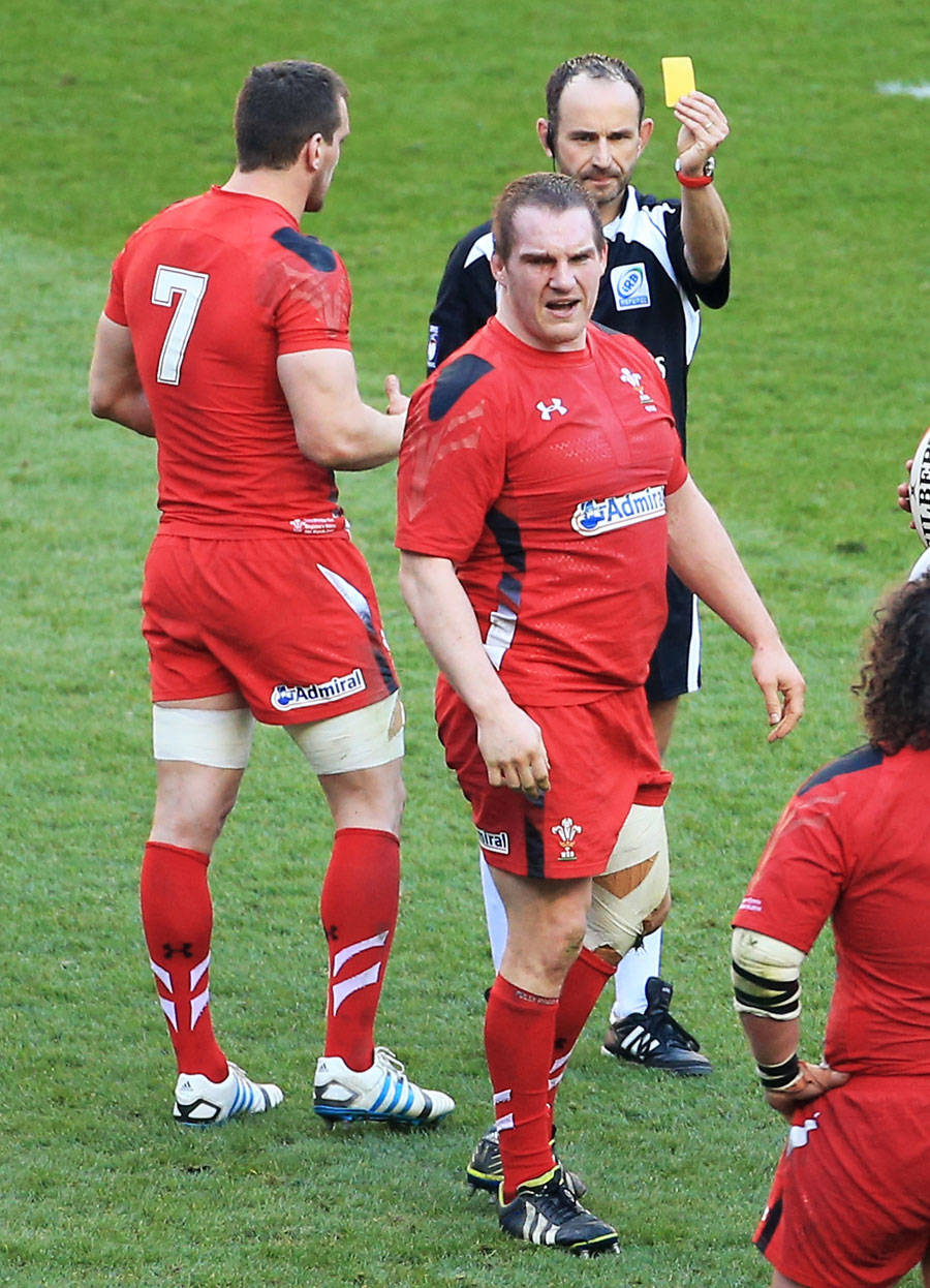 Gethin Jenkins is shown the yellow by referee Romain Poite
