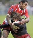 Biarritz's flanker Samiu Vahafolau tackles Toulouse's Maxime Medard