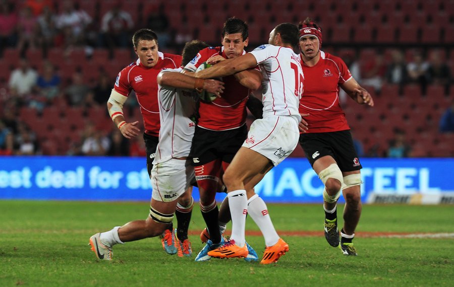 Lions' Marnitz Boshoff battles for the ball against Reds' Jake Schatz and Quade Cooper