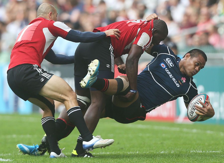Pohiva Lotoahea of Japan is tackled 