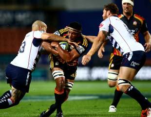 Tanerau Latimer of the Chiefs is tackled by the Rebels' Tamati Ellison, Melbourne Rebels v Chiefs, Super Rugby, Waikato Stadium, April 12, 2014