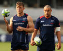 Jason Woodward and Tamati Ellison listen to instructions during a Melbourne Rebels training session