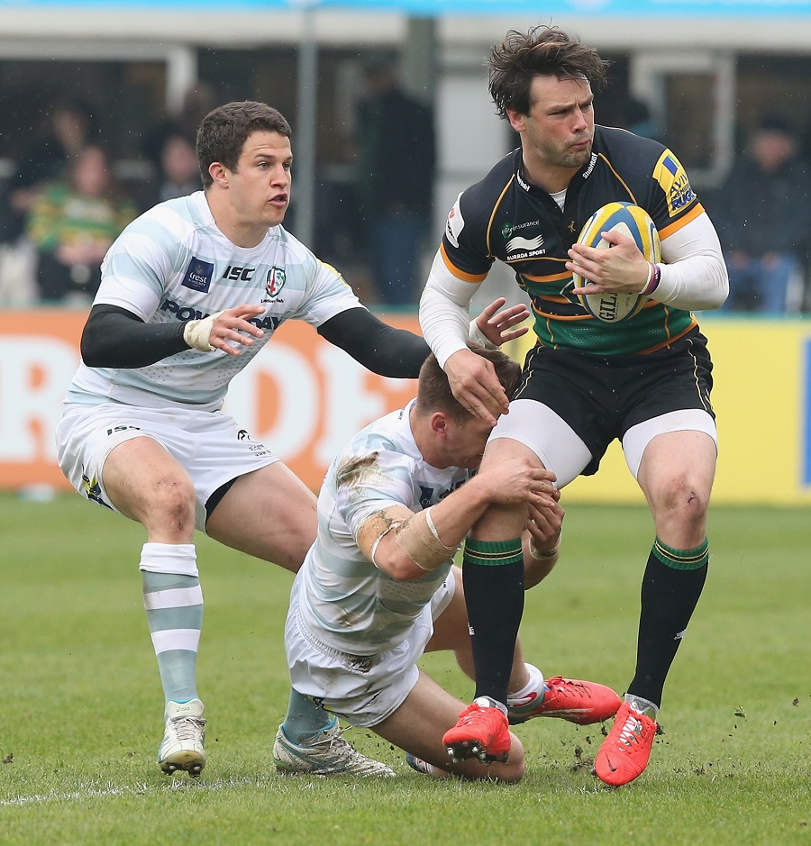 Ben Foden's locks are in full flow as he is tackled by Alex Lewington