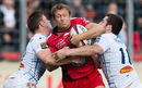 Toulon's Jonny Wilkinson is tackled by Castres's Rory Kockott and Remi Tales