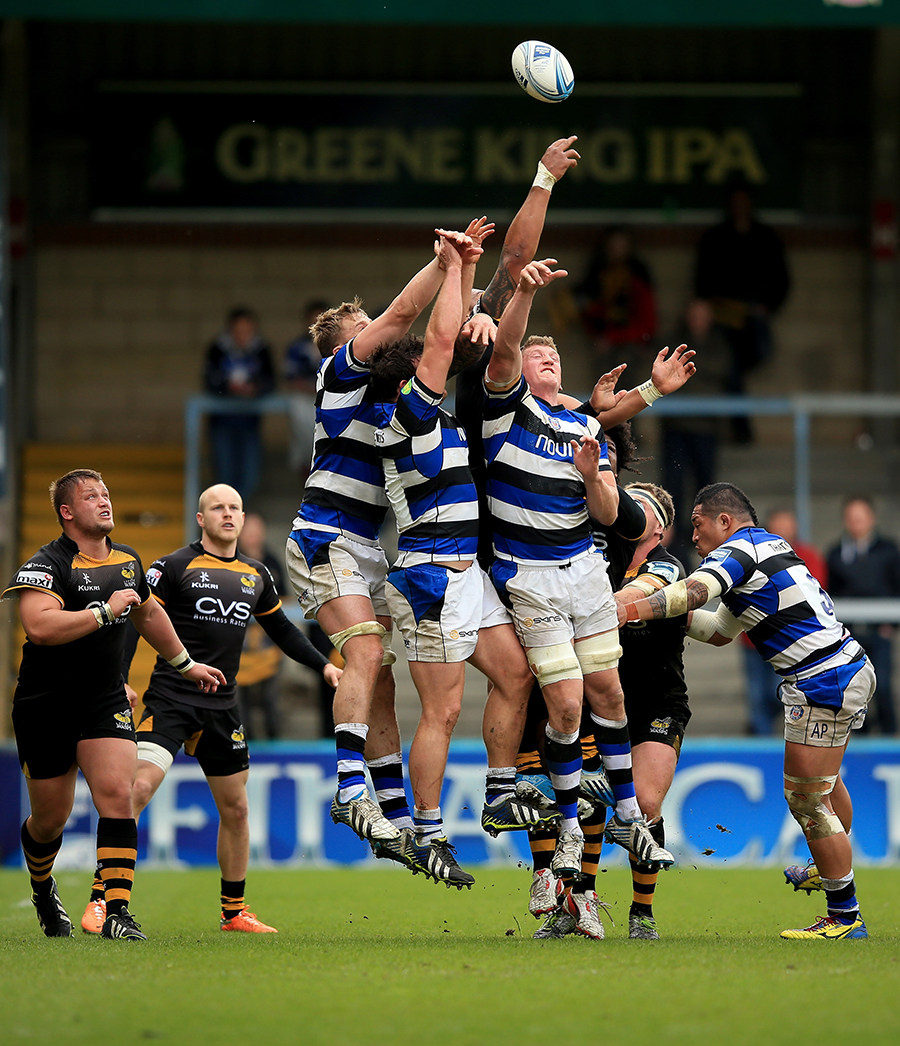 Bath and Wasps players jump in a tangle of limbs to win a loose lineout ball
