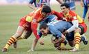 Stade Francais' Julien Arias is tackled by Perpignan's Adrien Plante and Gavin Hume