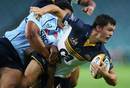 The Brumbies' Adam Ashley-Cooper is tackled by the Waratahs' defence