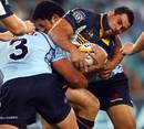 The Brumbies' George Smith is tackled by the Waratahs' defence