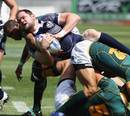 Scotland's Roland Reid is tackled by the South Africa defence