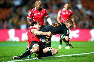 The Chiefs' Gareth Anscombe breaks the tackle of Franco Mostert to score a try, Super Rugby, Chiefs v Lions, Waikato Stadium, Hamilton, May 3, 2014 
