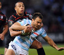 Racing Metro's Juan Martin Hernandez is wrapped up by Gael Fickou