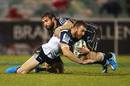 The Sharks' Cobus Reinach tackles the Brumbies' Nic White