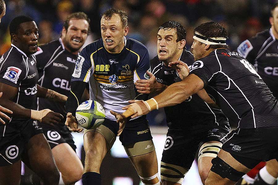 The Brumbies' Jesse Mogg passes the ball under pressure