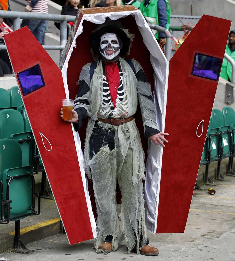 A spectator shows off his fancy dress at the London Sevens