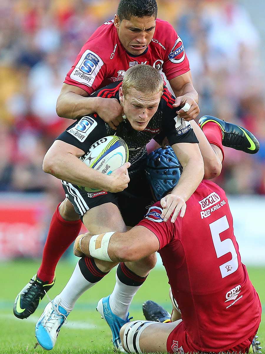 The Reds' James Horwill and Anthony Fainga'a tackle the Crusaders' Johnny McNicholl