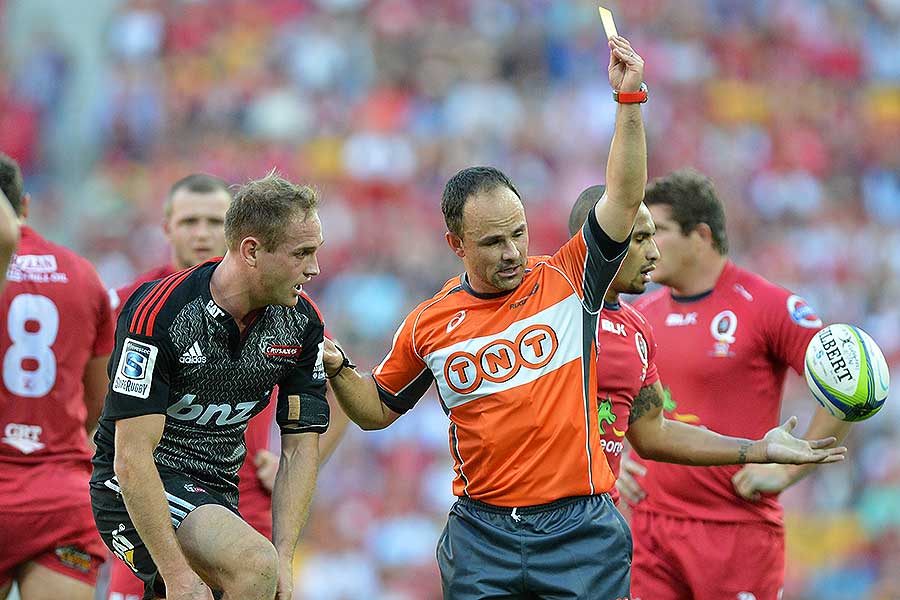 Jaco Peyper issues a yellow card to the Crusaders' Andy Ellis