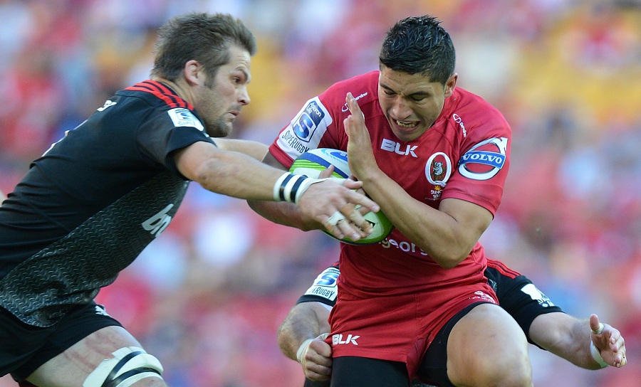 The Reds' Anthony Faingaa takes on the Crusaders' Richie McCaw