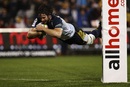 The Brumbies' Sam Carter leaps to score a try
